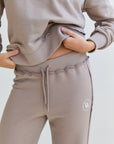 mocca Soft Straight line pants Your favorite essential for the winter. We added middle length laces & little rips in the end of the leg. With the DM logo in the upper part of the pants.